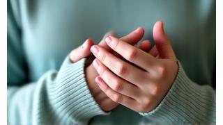 Person holding hands to chest calmly, indicating anxiety relief.