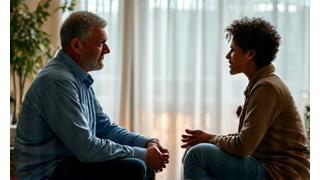Two people calmly communicating, representing positive interaction.