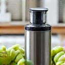 Modern cold-pressed juicer with fresh fruits and vegetables.