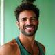 Fit man in his early 40s in athletic wear, smiling after a workout.